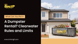 Bin King dumpster outside a Clearwater home filled with yard waste, showing what can go into a rental bin according to local rules.