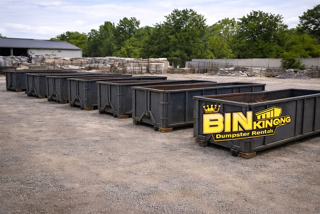 Multiple Bin King dumpsters lined up in a staging area, ready for use at various contractor and remodeling job sites.